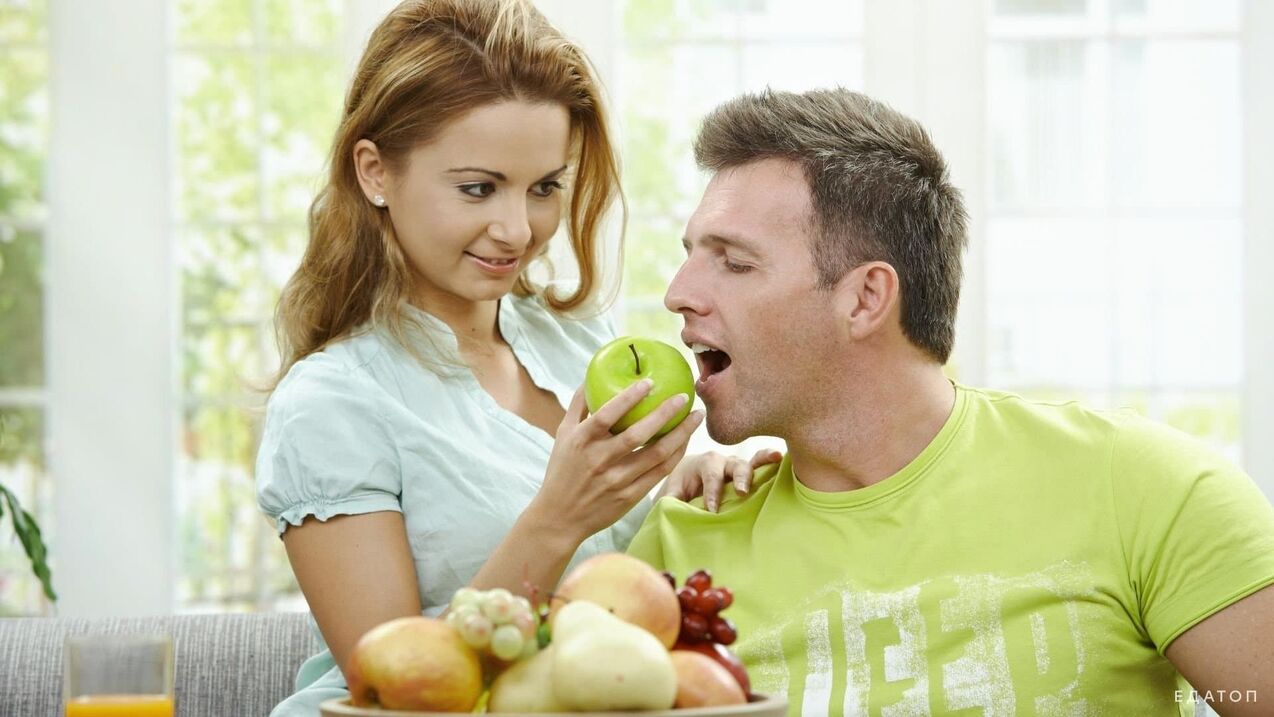 the girl feeds the man with healthy food
